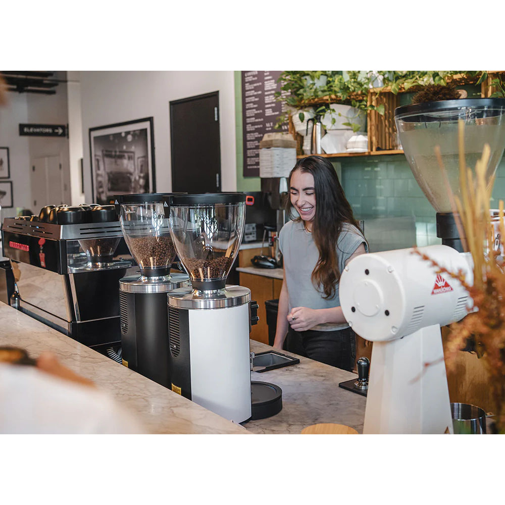 Black & white Mahlkönig E80W GbS grinders on a café bar