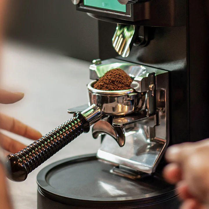 Black Mahlkönig E80W GbS grinder with espresso portafilter on the tray