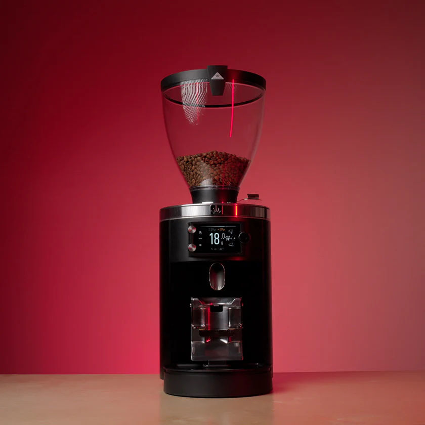 Black Mahlkönig E80W GbS grinder against a red background