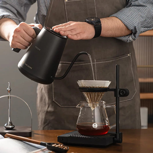 Barista pouring with the Timemore Fish Pro X gooseneck kettle over a pour-over brewer