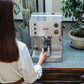 Lelit Elizabeth V3 PID domestic espresso machine with woman and mug under group head